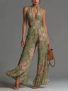 White sleeveless chiffon dress with V-neck, zipper, and wide pleated pants